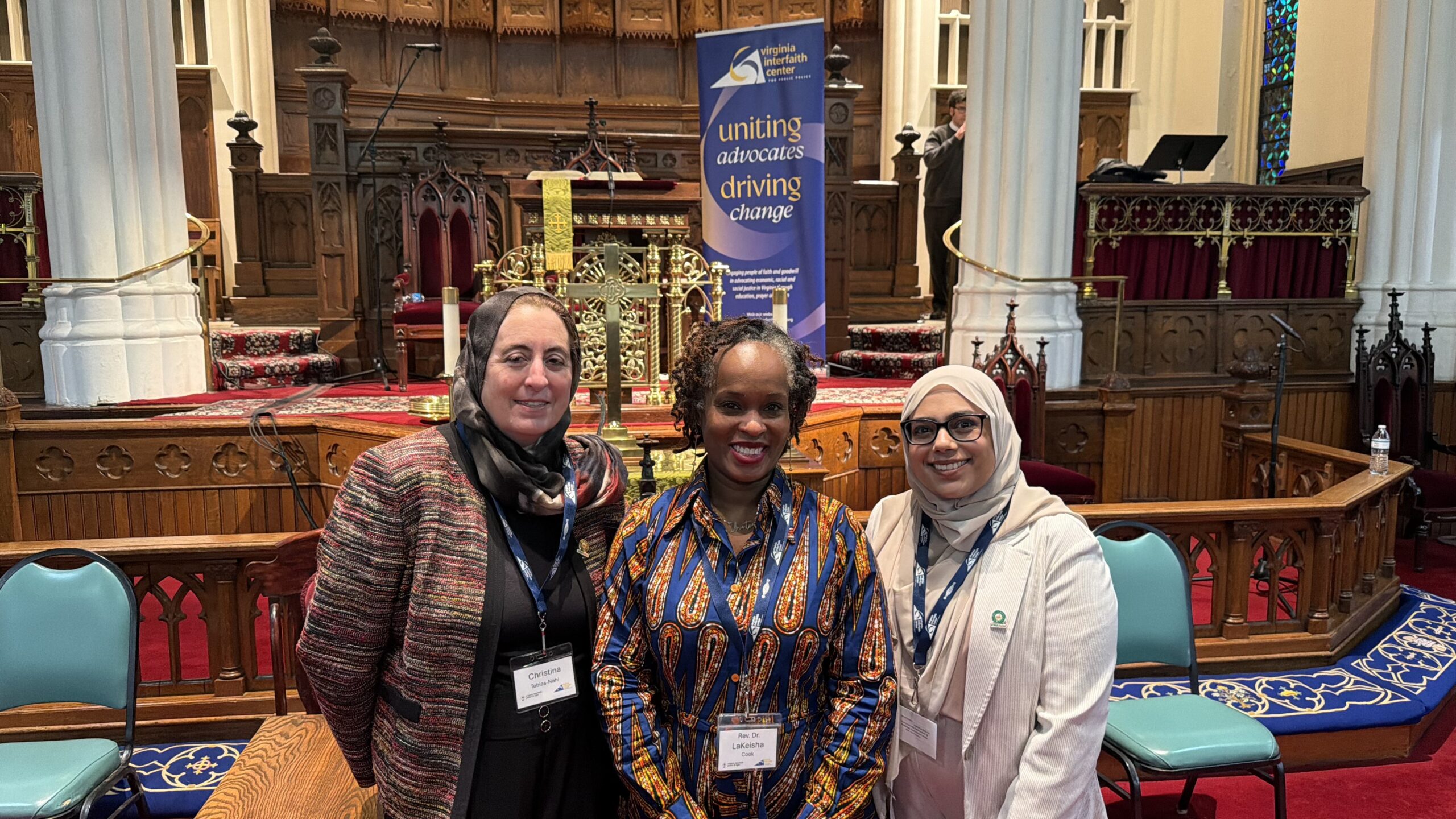 three women standing in a sanctuary