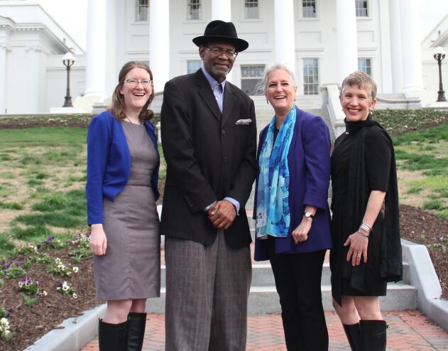 four people standing in front of virginia state capitol