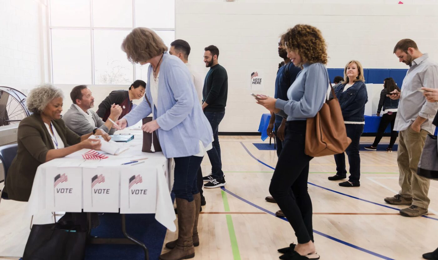 people waiting in line to vote at polling place