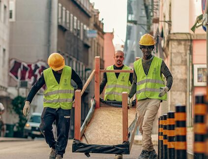 3 workers with yellow vests walking
