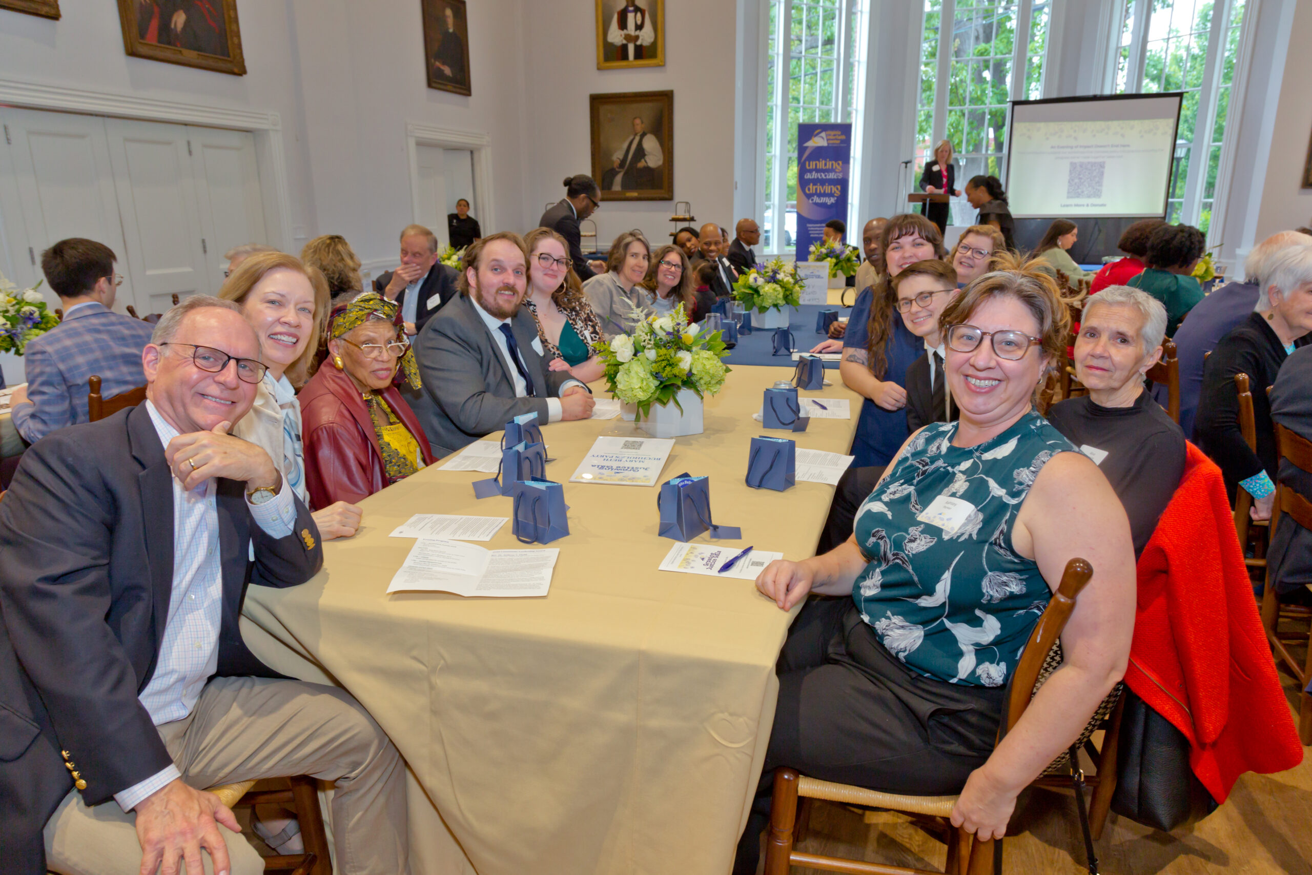 people sitting at both sides of a long table