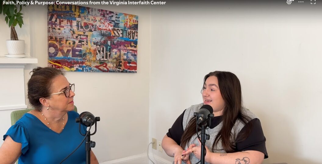 two women talking with microphones in front of them