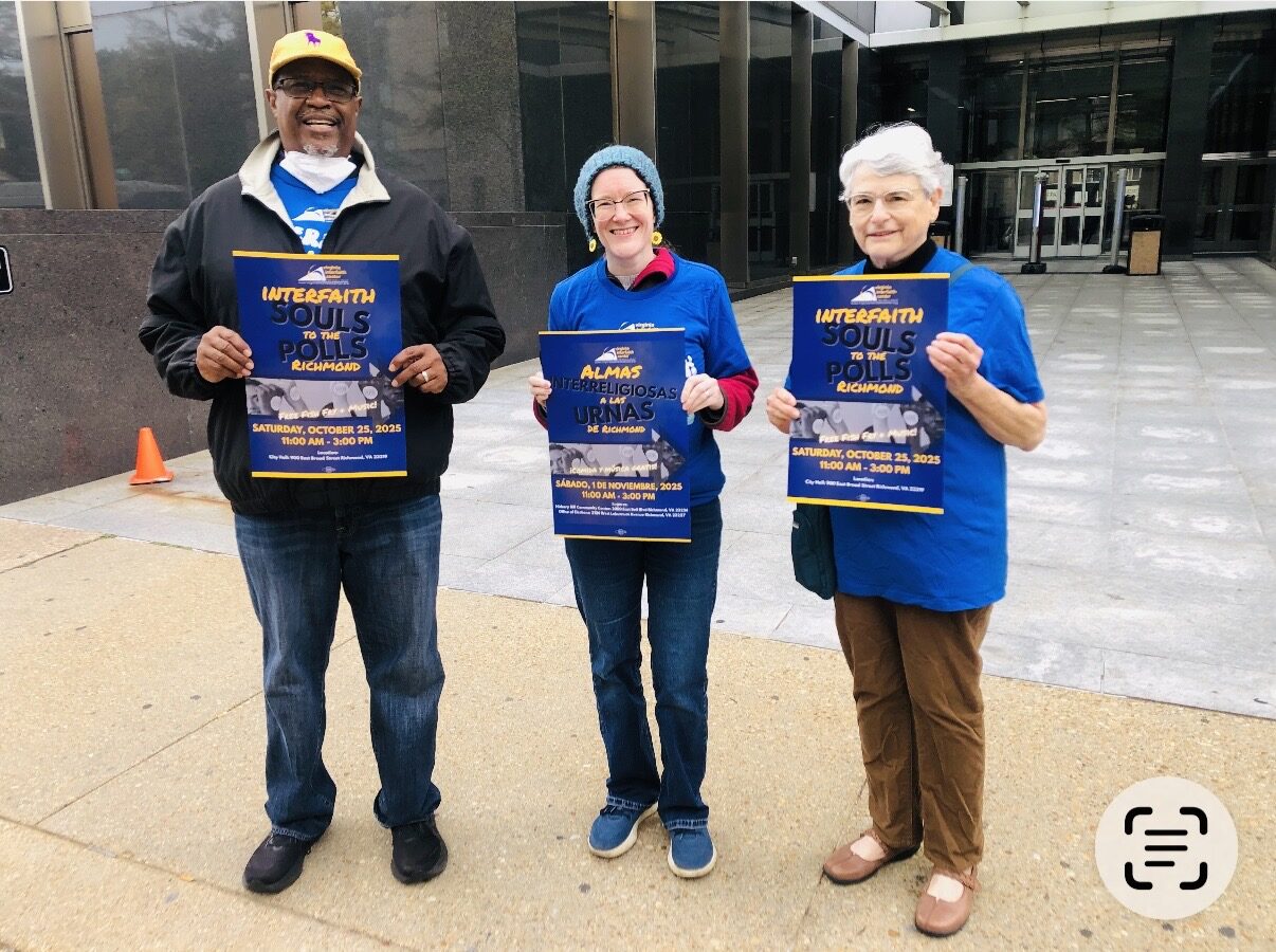 three people holding posters for Souls to the Polls