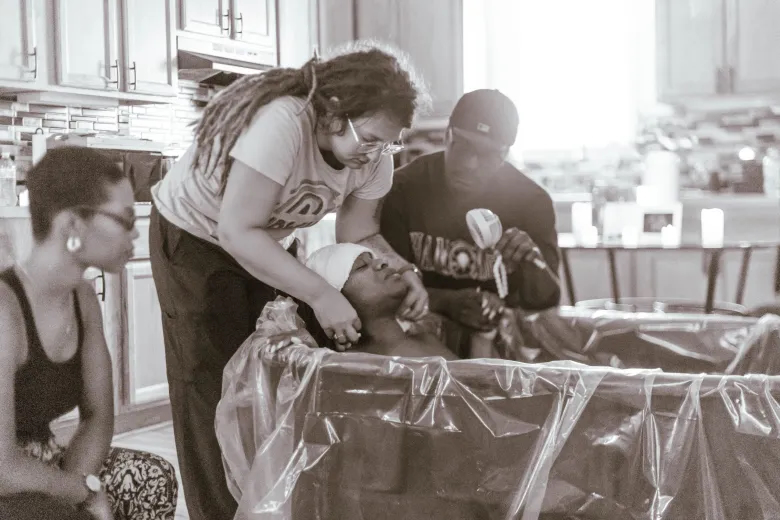 midwife helping mom deliver baby